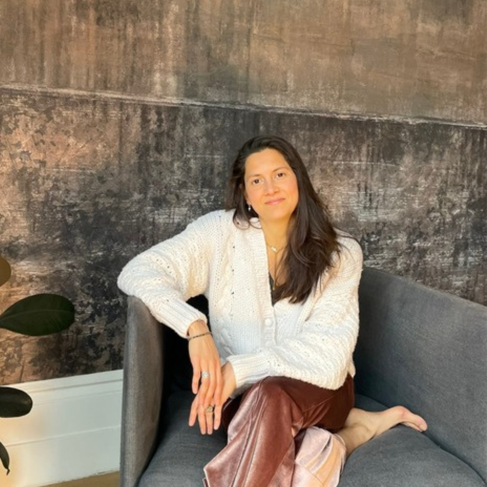 Fay seated quietly in an armchair, at ease
