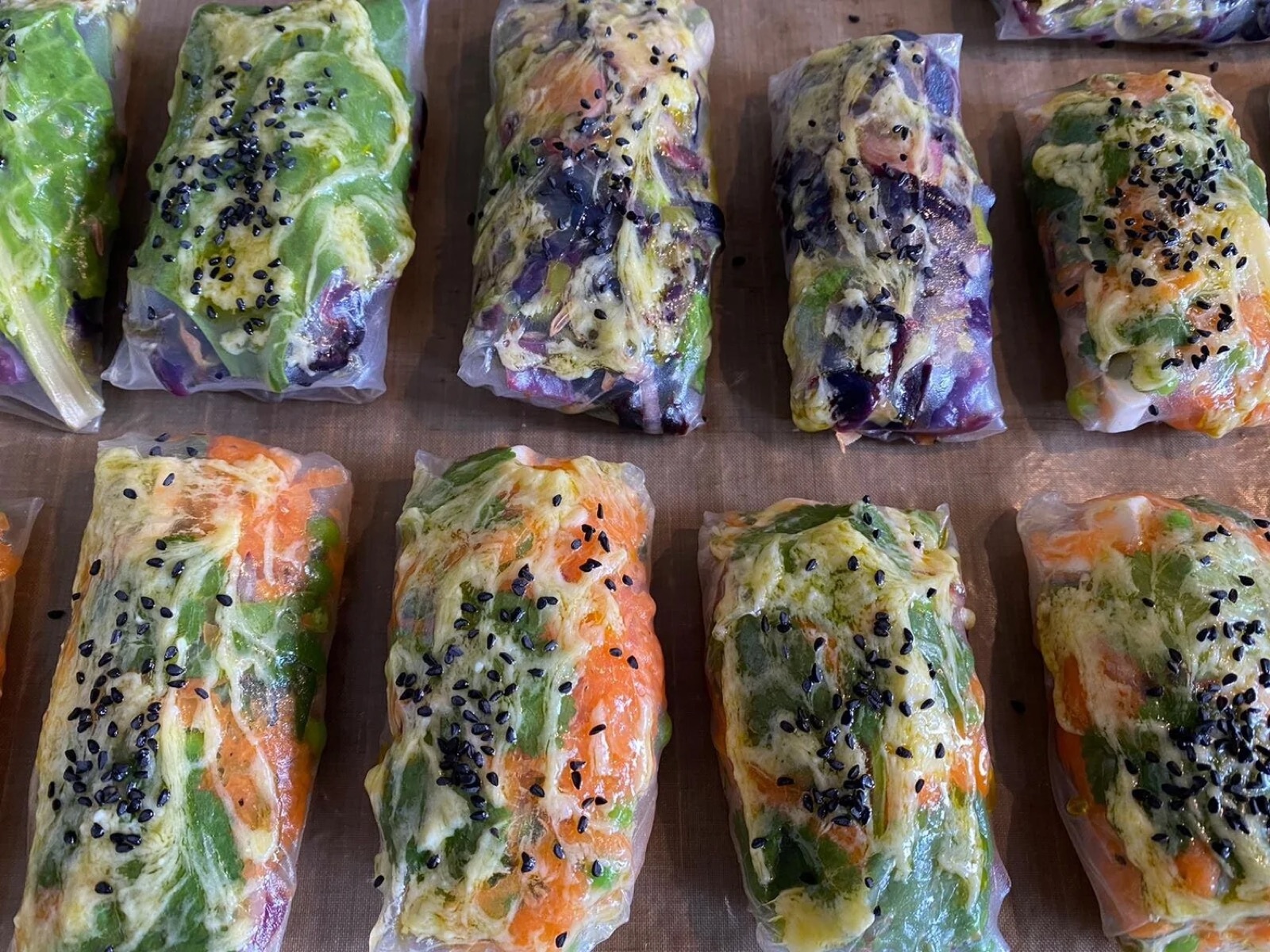 Steamed rainbow vegetable rice-paper packets with black sesame
